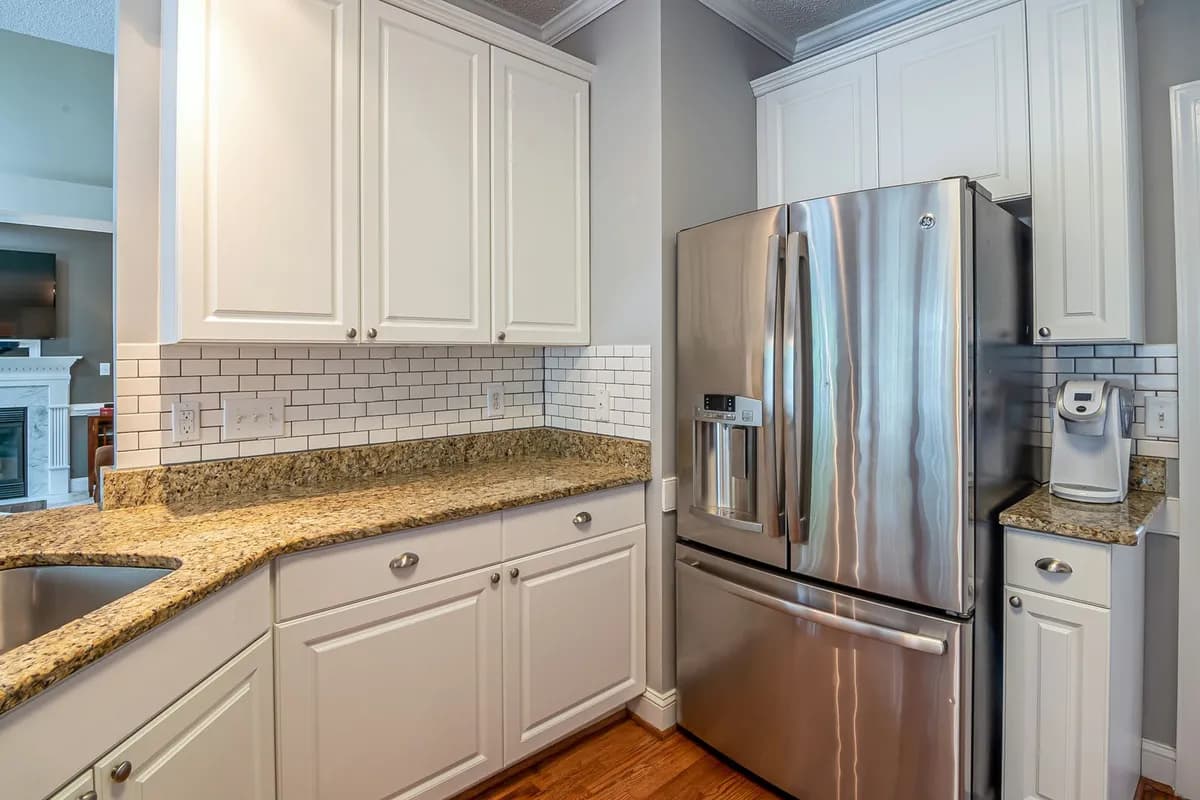 Stainless steel refrigerator with an ice and water dispenser in a bright kitchen